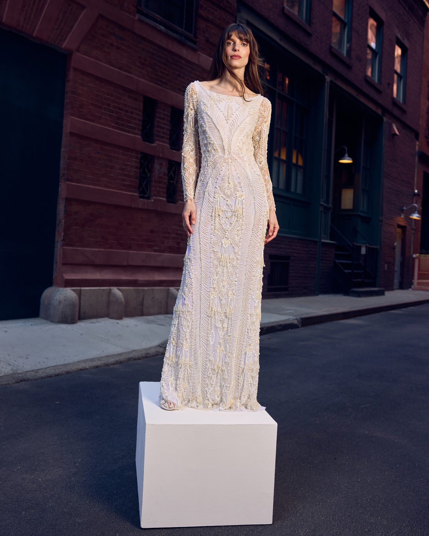 A hand-beaded PatBO gown on a plinth in a New York street, from the bridal campaign