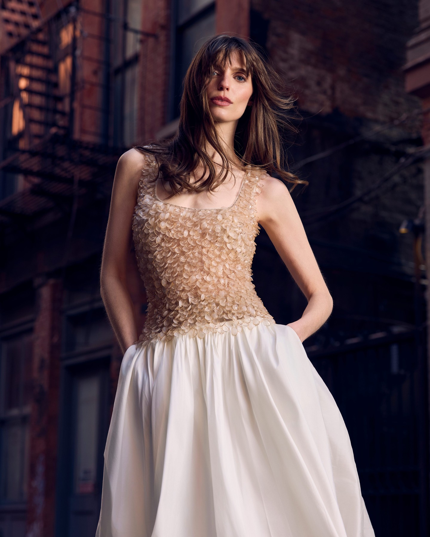 A petal-embellished bodice and full white skirt, up close