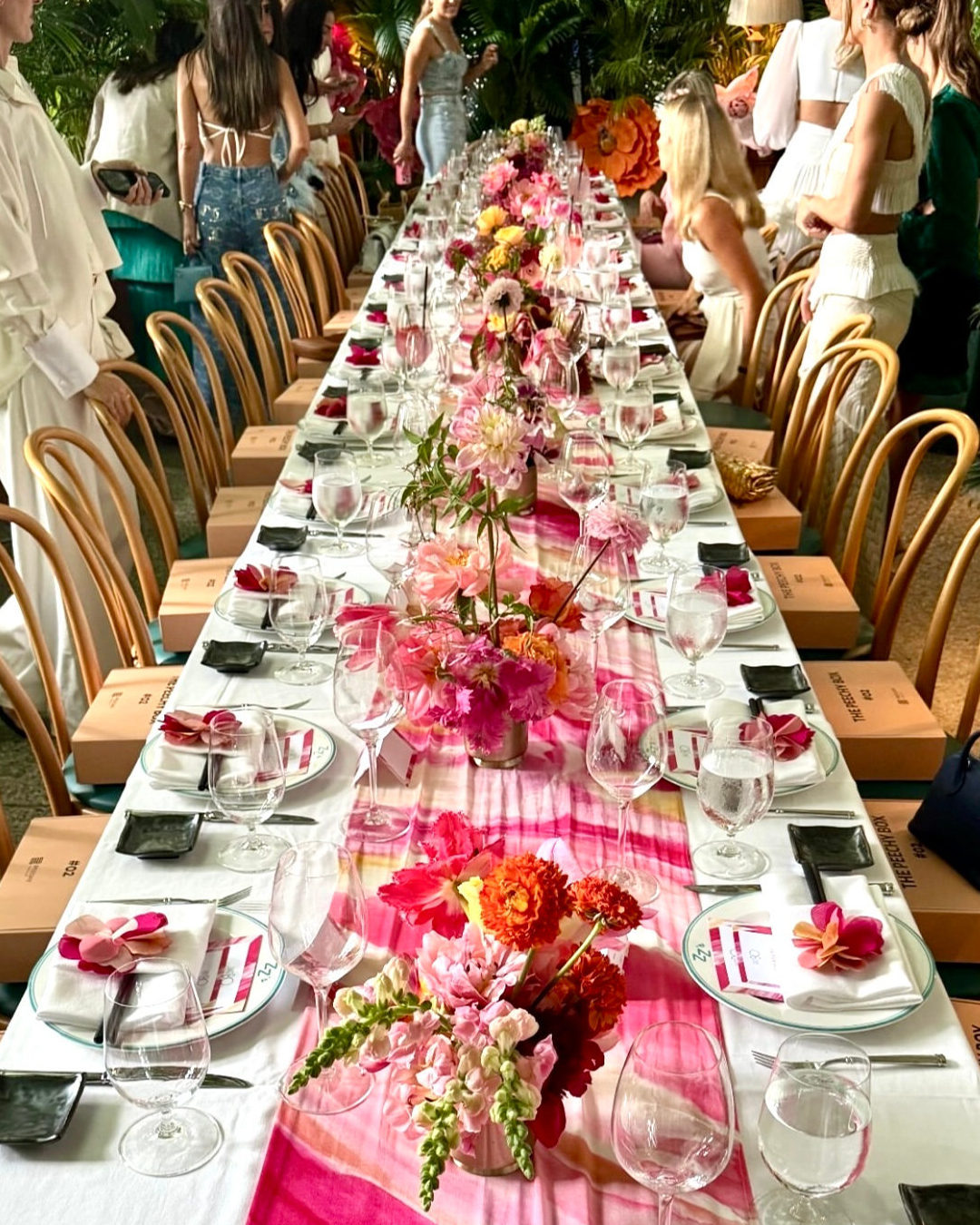 The long lunch table dressed in pink florals and a hand-dyed runner