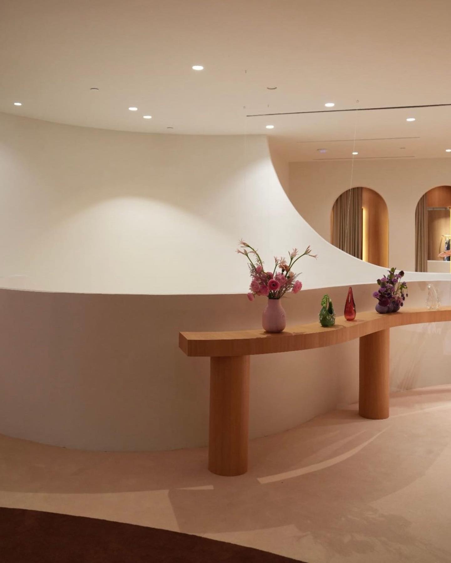 The store’s curved plaster interior with hand-blown glass on a wood console