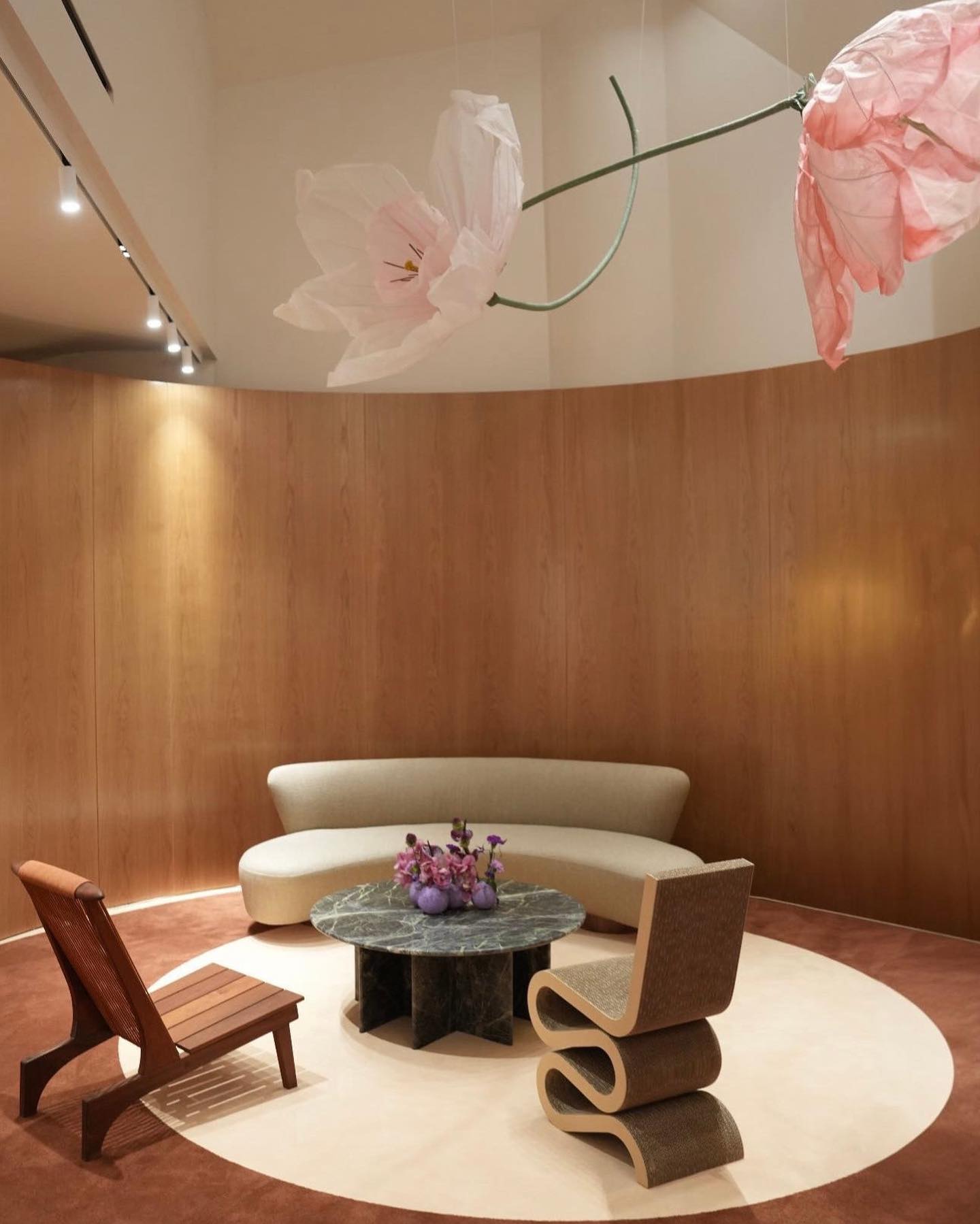 The lounge with curved sofa and hanging paper tulips