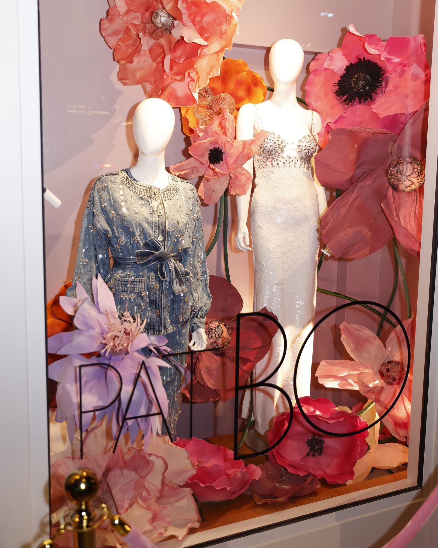The opening window: mannequins among giant paper poppies