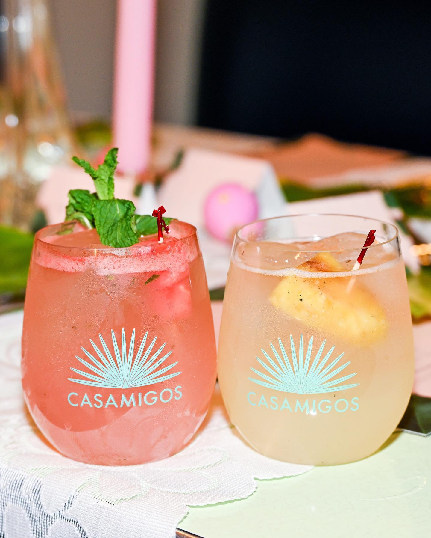 Casamigos cocktails with pink candles on the lace tablecloth