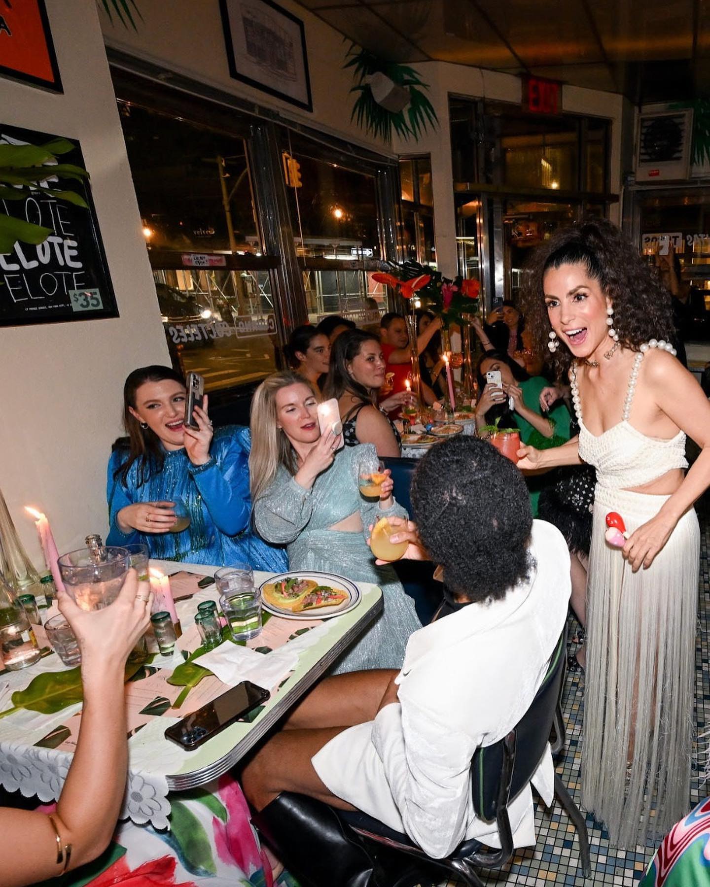 Patricia Bonaldi toasting with guests along the dinner table