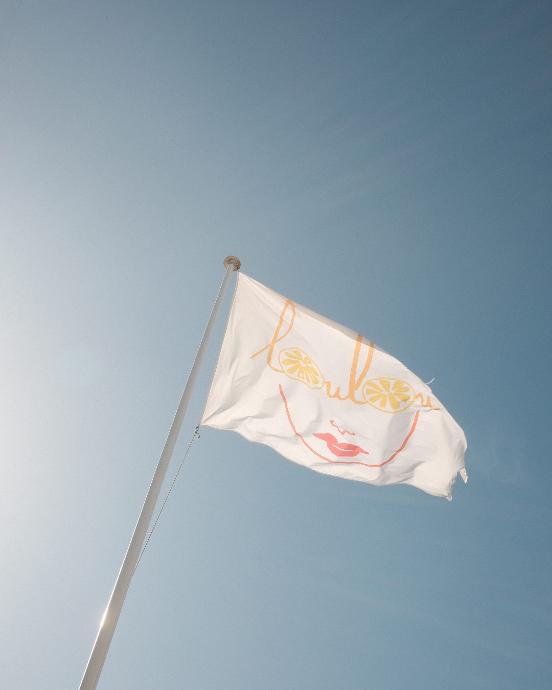 The LouLou flag against a clear sky