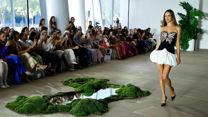 PatBO runway presentation with seated audience and reflecting pool