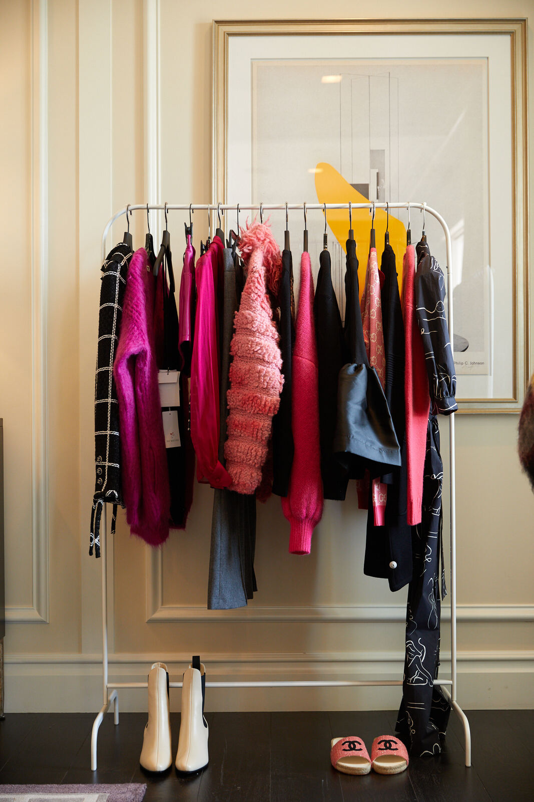Curated rack of designer pieces in the suite