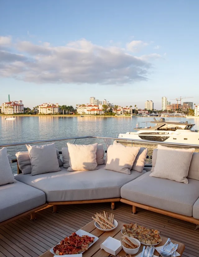 The aft deck set with food, Fisher Island behind