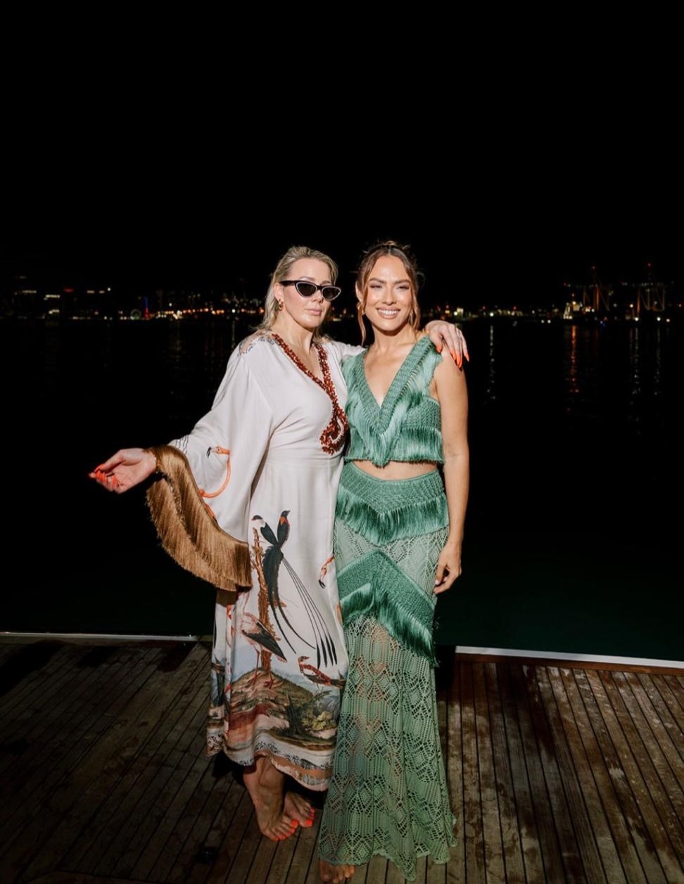 Two guests on deck with the port lights behind