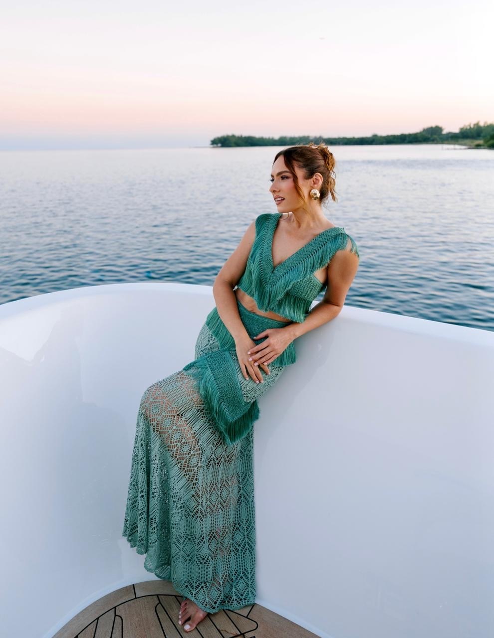 Patricia Bonaldi in PatBO on the bow at sunset