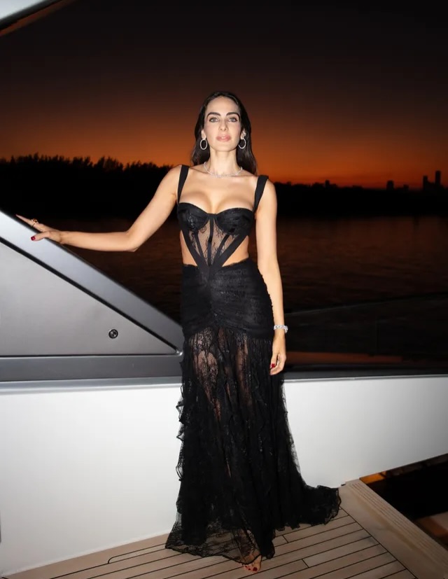 A guest in black lace against the last of the sunset